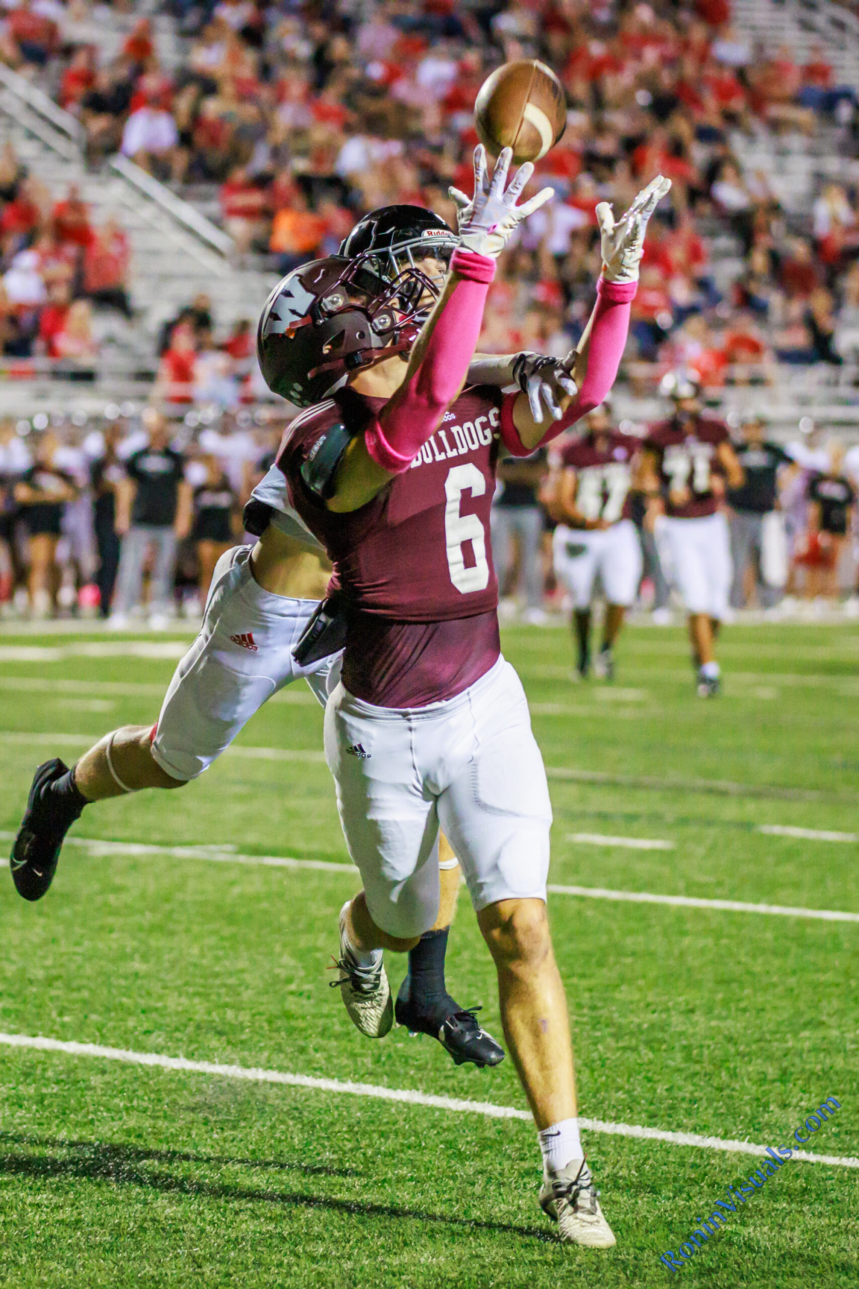 Austin Bice (6) hauls in a touchdown pass with a Tomball defender attempting to break up the play. The Waller High School Bulldog football players fell to the Tomball Cougars, 42-8, at Waller ISD Stadium on Friday, Oct. 6, 2023. (Photo courtesy RoninVisuals.com)