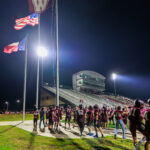 The Waller Bulldog football team raises the victory flag at home for the first time since 2021, after defeating Conroe Caney Creek, 41-7, at Daikin Stadium, Aug. 31, 2024. (Photo by Creighton Holub, courtesy RoninVisuals.com)