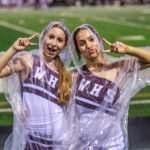 Bulldog cheerleaders keep spirits high as a drizzling rain sets in during the second game of the year. The Waller Bulldog football team slips against Conroe Grand Oaks, 17-14, for the Bulldog’s first loss of the 2024 campaign, at Moorehead Stadium in Conroe, Sept. 5, 2024. (Photo by Creighton Holub, courtesy RoninVisuals.com)